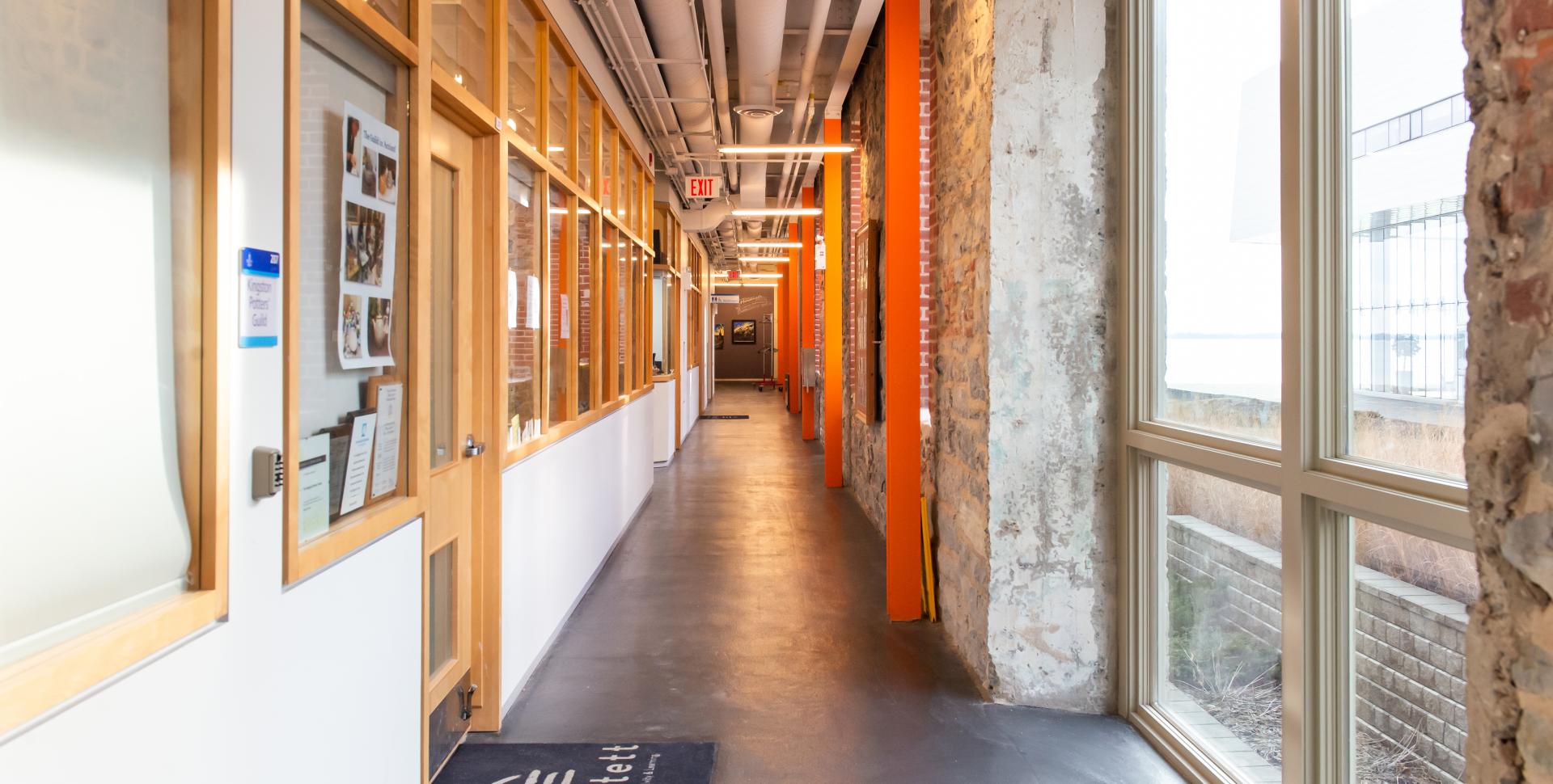 A view of a brightly lit hallway on the second floor of the Tett.  