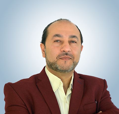 Headshot of Jabra Mitwasi wearing a collared shit and a maroon jacket. 