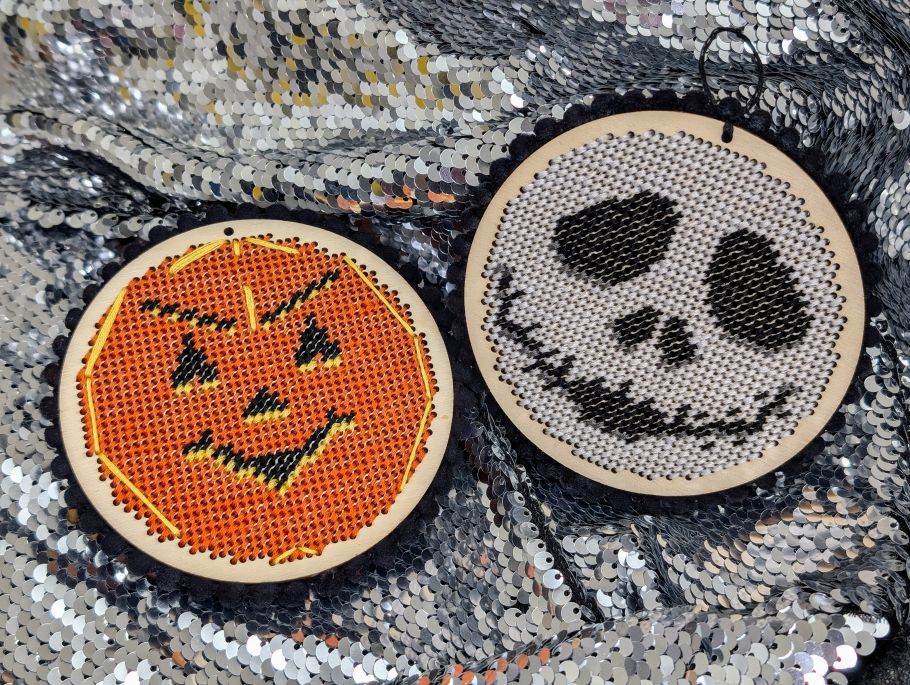 A crocheted pumpkin and skeleton head. 