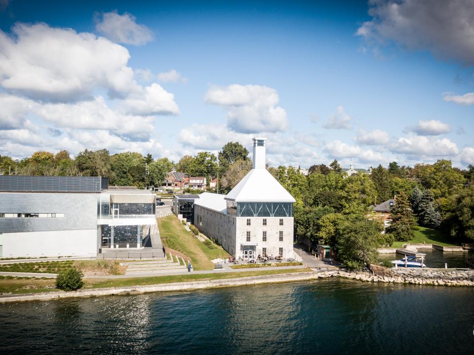 A white-roofed building located at the waterfront, providing ample space for various activities and services.