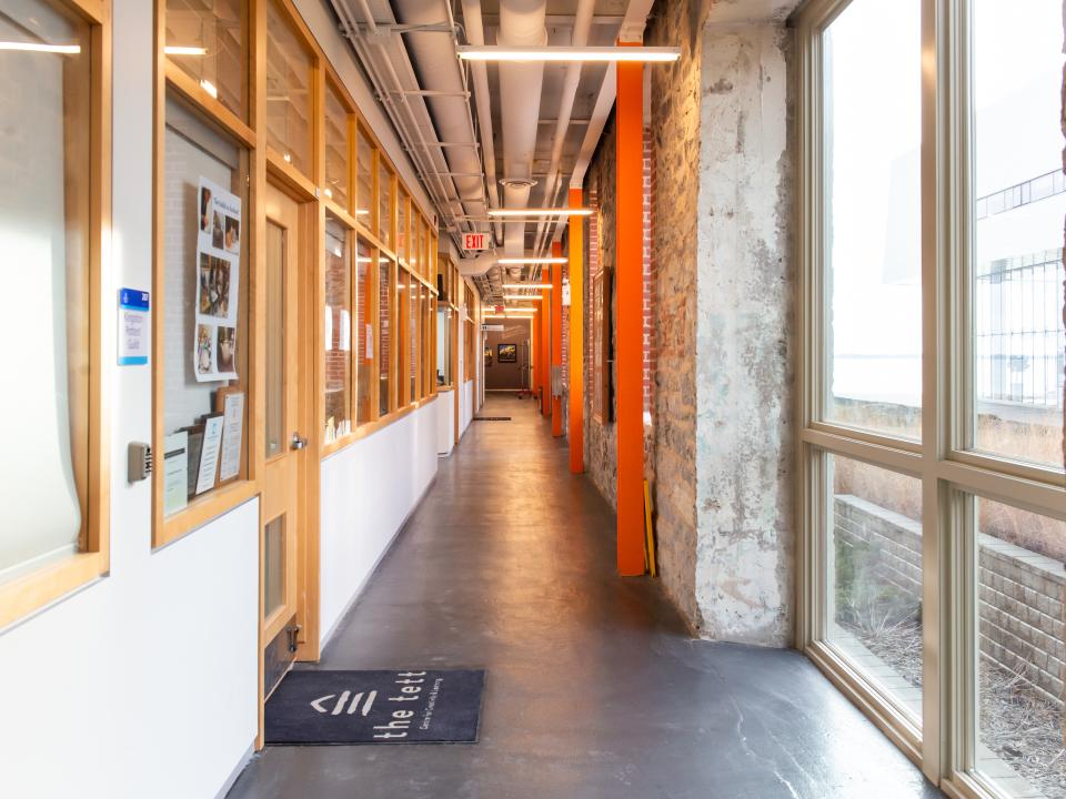 A view of a brightly lit hallway on the second floor of the Tett.  